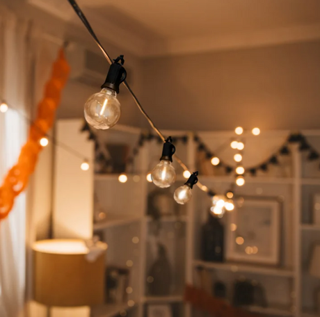 String of light bulbs hanging in a room 
